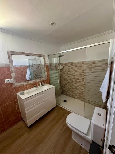 a bathroom with a toilet and a sink and a shower at House Beach in Bolonia