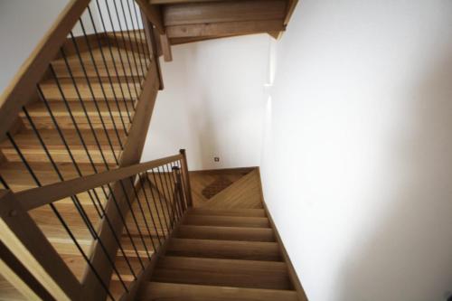 a staircase in a house with wooden stairs at Le Vignole in Vezzano
