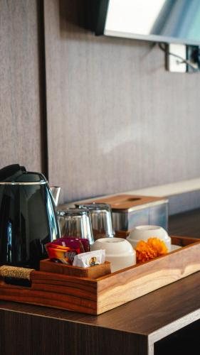 a wooden tray with food on a table at Tut Winten a Tranquil Living Villa Ubud in Ubud