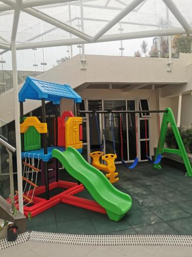 a playground with a slide and swings at City Hub 523 in Baguio