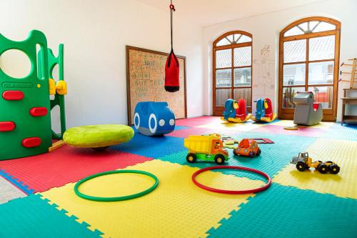a childs play room with toys on the floor at Hotel am Badepark Waldkirchen in Waldkirchen