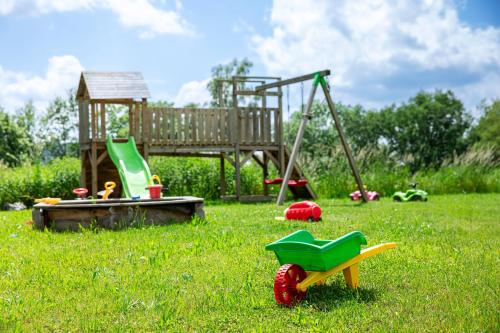 a park with a playground and a play set in the grass at Hotel am Badepark Waldkirchen in Waldkirchen