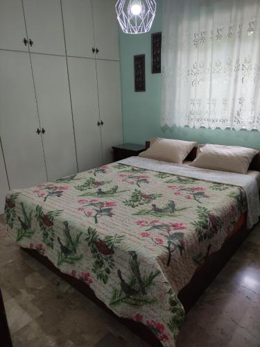 a bedroom with two beds with a quilt on it at Plateia Home in Kardítsa