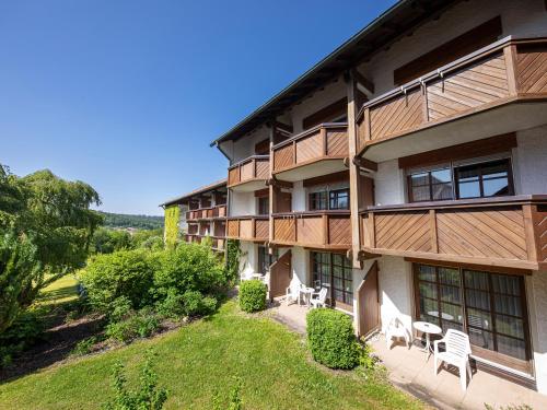 an exterior view of a building with tables and chairs at Hotel am Badepark Waldkirchen in Waldkirchen
