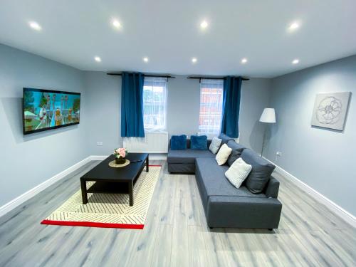 a living room with a couch and a table at Spacious 2-Bedroom Flat in London - F3 in London