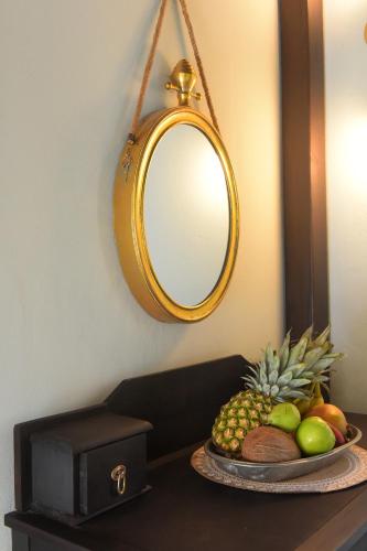 a plate of fruit on a table with a mirror at Elaia-Fos in Rhodes Town