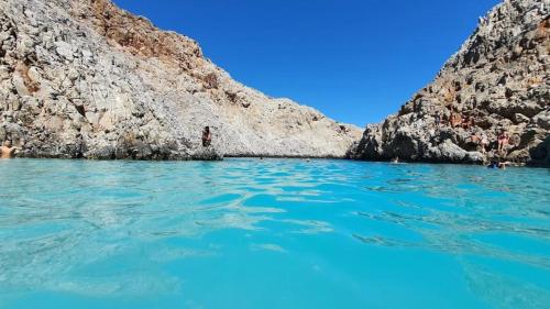 a body of water next to a rocky cliff at Luxury Oasis in Chania - Private Pool, BBQ & Garden by WeHome in Chania Town