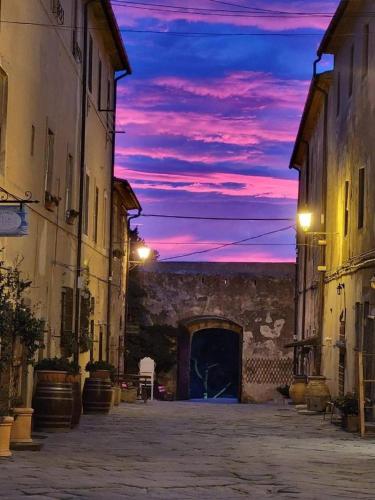 an empty street with a sunset in the background at Populonia corso apartment in Populonia