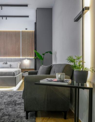 a living room with a couch and a table at Aristotelian Virtues - Tharros in Thessaloniki