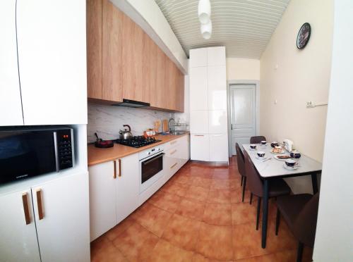 a kitchen with a table and a dining room at Apartment Medea Batumi in Batumi