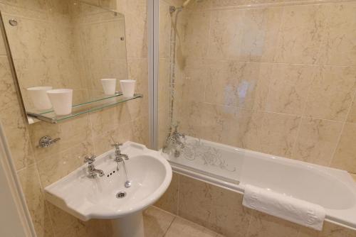 a bathroom with a sink and a bath tub at Rowsley Cottage Bakewell Peak District in Bakewell