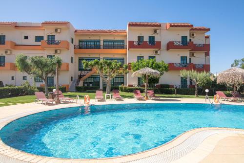 a large swimming pool in front of a building at Portokali Apartments in Hersonissos
