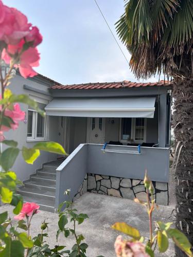 a house with stairs and a stair case at Amaya Pine Rooms in Keramotí