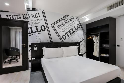 a bedroom with a white bed and posters on the wall at Verdi Gzira Promenade in Sliema