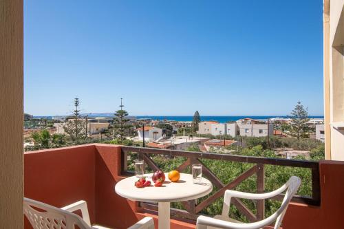 a balcony with a table with fruit on it at Portokali Apartments in Hersonissos