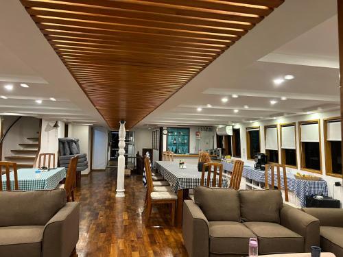 a living room with couches and tables and a wooden ceiling at Maldives Safary Tours in Male City
