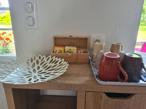 a counter with a tray with cups and a plate at A la Campagne ,Halte ,Séjour et Détente in Moncontour-de-Poitou