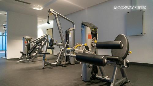 a gym with several tread machines in a room at MOONWAY SUITES At EATON KLCC in Kuala Lumpur