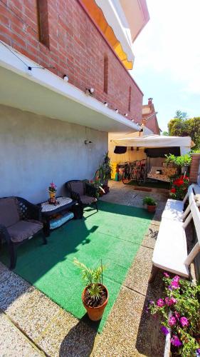 a patio with a green floor and a building at Bed& Breakfast G&G in Porto Garibaldi