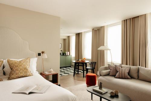 a hotel room with a bed and a couch at Native Kings Wardrobe, St Pauls in London