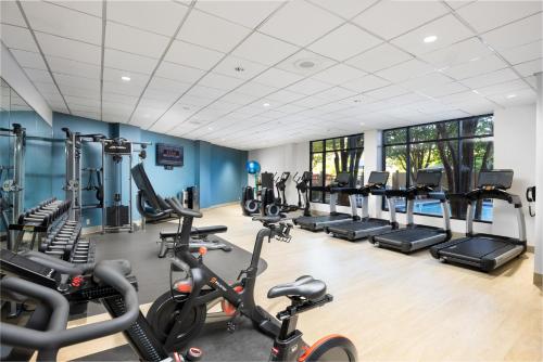 a gym with several treadmills and cardio machines at DoubleTree by Hilton Houston Medical Center Hotel & Suites in Houston