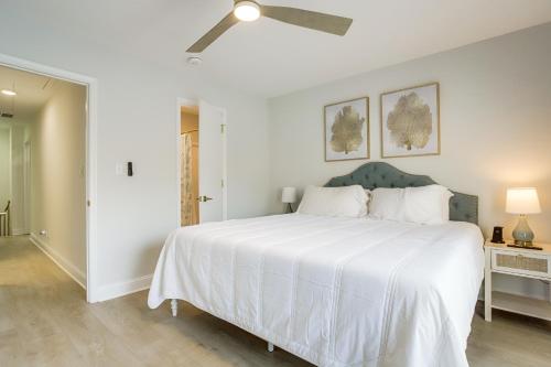 a bedroom with a white bed with a ceiling fan at Walk to Shore and Boardwalk Bethany Beach Retreat in Bethany Beach