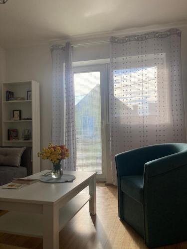 a living room with a couch and a table and a chair at Apartman Zlatija in Bajina Bašta