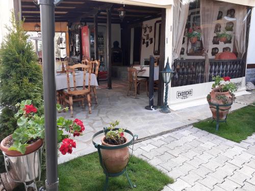 a patio with a table and some potted plants at Restaurant and Apartments - T'ga za Jug Lazaropole in Lazaropole