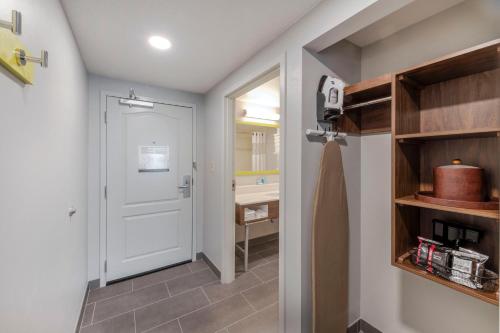 a bathroom with a white door and a sink at Hampton Inn & Suites Burlington in Burlington