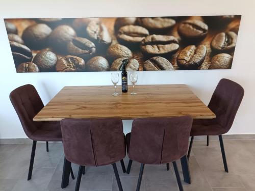 a dining room table with two wine glasses on it at Apartmani Frane in Vir