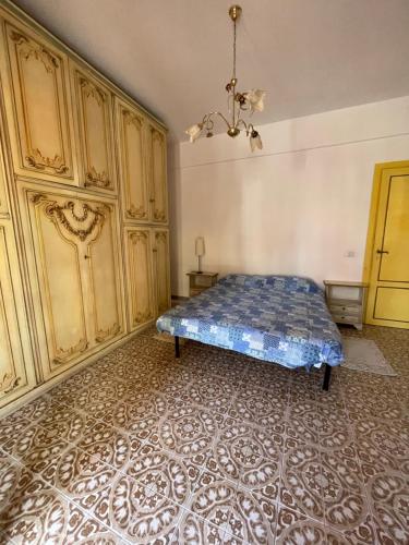 a bedroom with a bed and wooden cabinets at Ladispoli Seahouse in Ladispoli