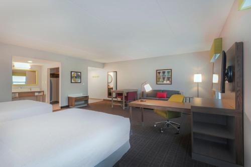 a hotel room with a bed and a desk at Hampton Inn & Suites Burlington in Burlington