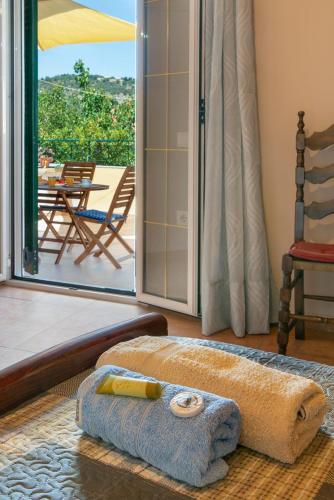 a room with a towel and a sliding glass door at Katia Apartments in Gaios