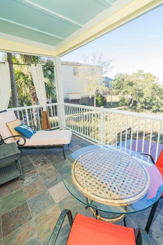 a patio with a table and chairs on a balcony at Water's Edge Inn - Adults Only in Folly Beach