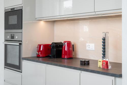a kitchen with red appliances on a counter at Montreux Four Bedroom Penthouse by Swiss Hotel Apartments in Montreux