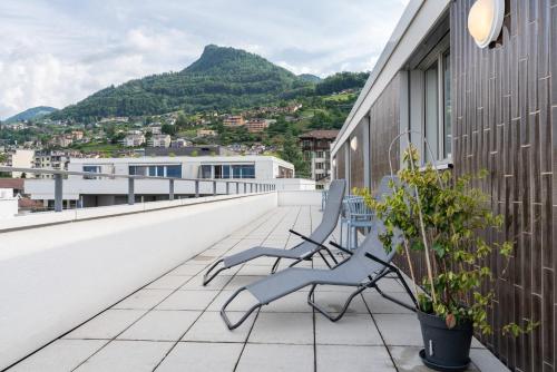 a couple of benches sitting on the roof of a building at Montreux Four Bedroom Penthouse by Swiss Hotel Apartments in Montreux