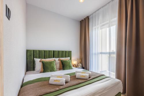 a bedroom with a bed with two pillows on it at Emihouse Riverside Apartments in Rzeszów