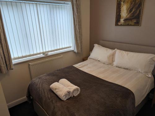 a bed with a towel on it in a bedroom at The Annex in Caernarfon
