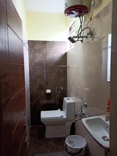 a small bathroom with a toilet and a sink at Soma Peaceside accommodation services in Bengaluru