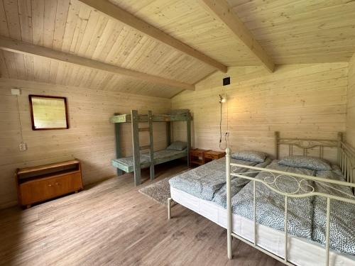 a room with two bunk beds in a cabin at Kuriste camping in Kuriste