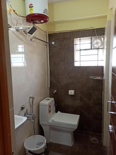 a small bathroom with a toilet and a sink at Soma Peaceside accommodation services in Bengaluru
