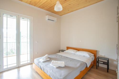a bedroom with a large bed with white sheets at Billy's Luxury Apartment in Vlikhón