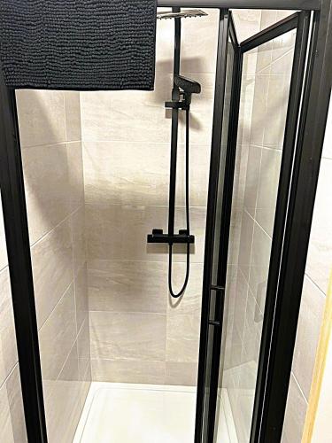 a shower in a bathroom with a glass door at No 2 The Arch in Carndonagh