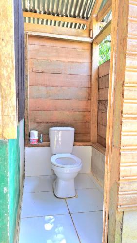a toilet sitting inside of a wooden structure at Ahuma Hospedaje in San Martín