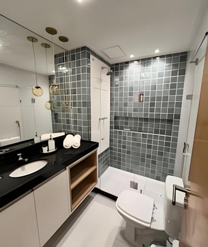 a bathroom with a sink and a toilet at Makia Beach Experience in Ipojuca