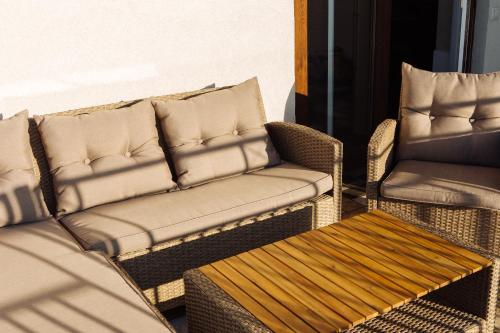 a living room with a couch and a chair at Penthouse Vacation in Moldova! in Chişinău