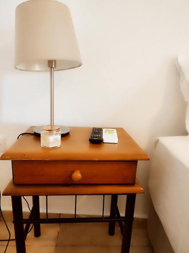 a table with a lamp on it next to a bed at Porto Kagio Villa View in Akhíllion