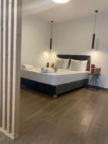 a bedroom with a large bed with white pillows at Oniropetra Luxury Suites in Kastéllion