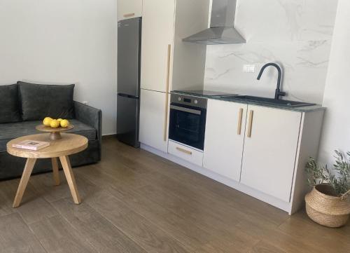 a kitchen with a couch and a table in a room at Oniropetra Luxury Suites in Kastéllion