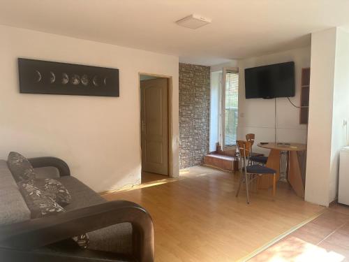 a living room with a couch and a table at Apartment GreenTerrace next to TC BIG FASHION Mall in Karaburma